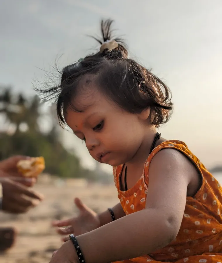 A little girl playing on a beach
